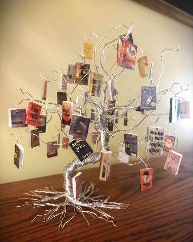 a wire tree with mini banned books hanging on it
