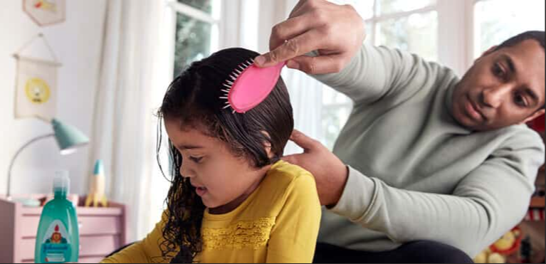 photo of a dad fixing a little girl's hair