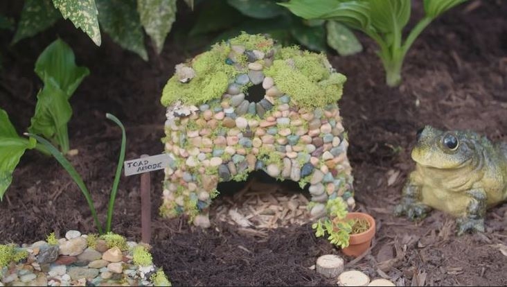 Photo of a pebble and moss-covered toad house