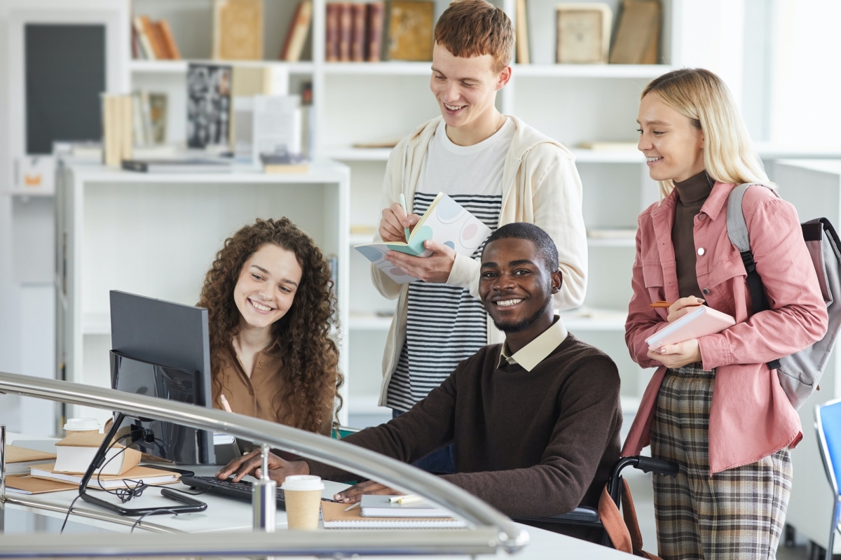 diverse group of students using computer in school
